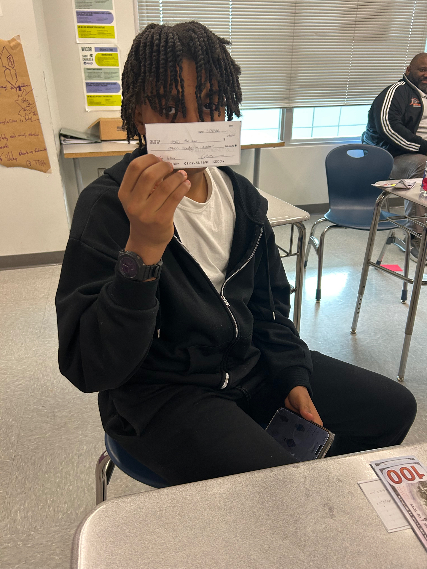 Student showing a check after completing a program milestone